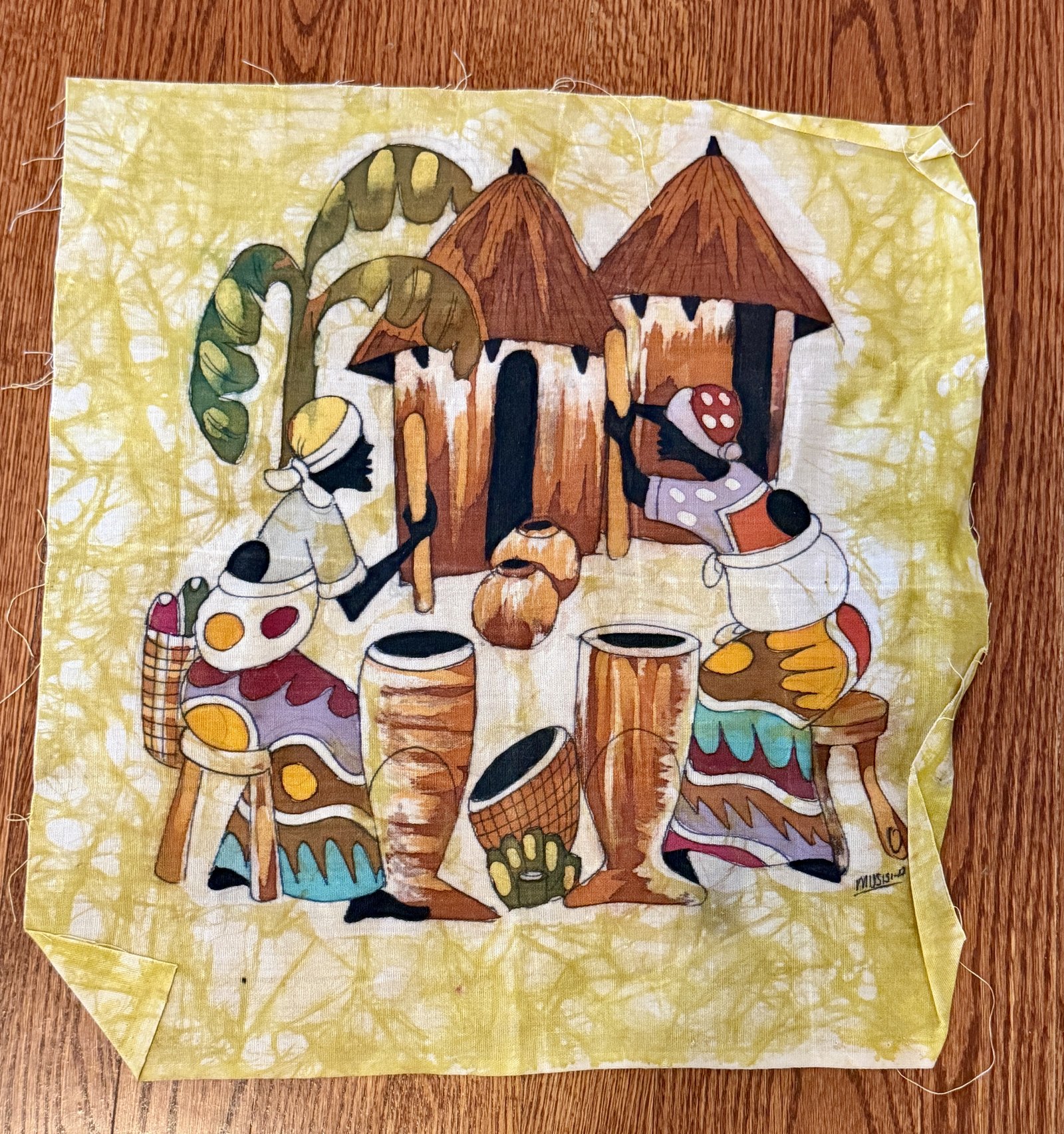 Batik africain, scène de village avec greniers coniques et femmes pilant le grain, fond jaune